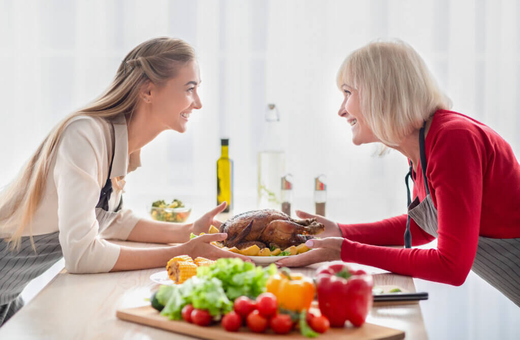 happy young woman and her senior mother serving ta 2023 11 27 05 13 43 utc