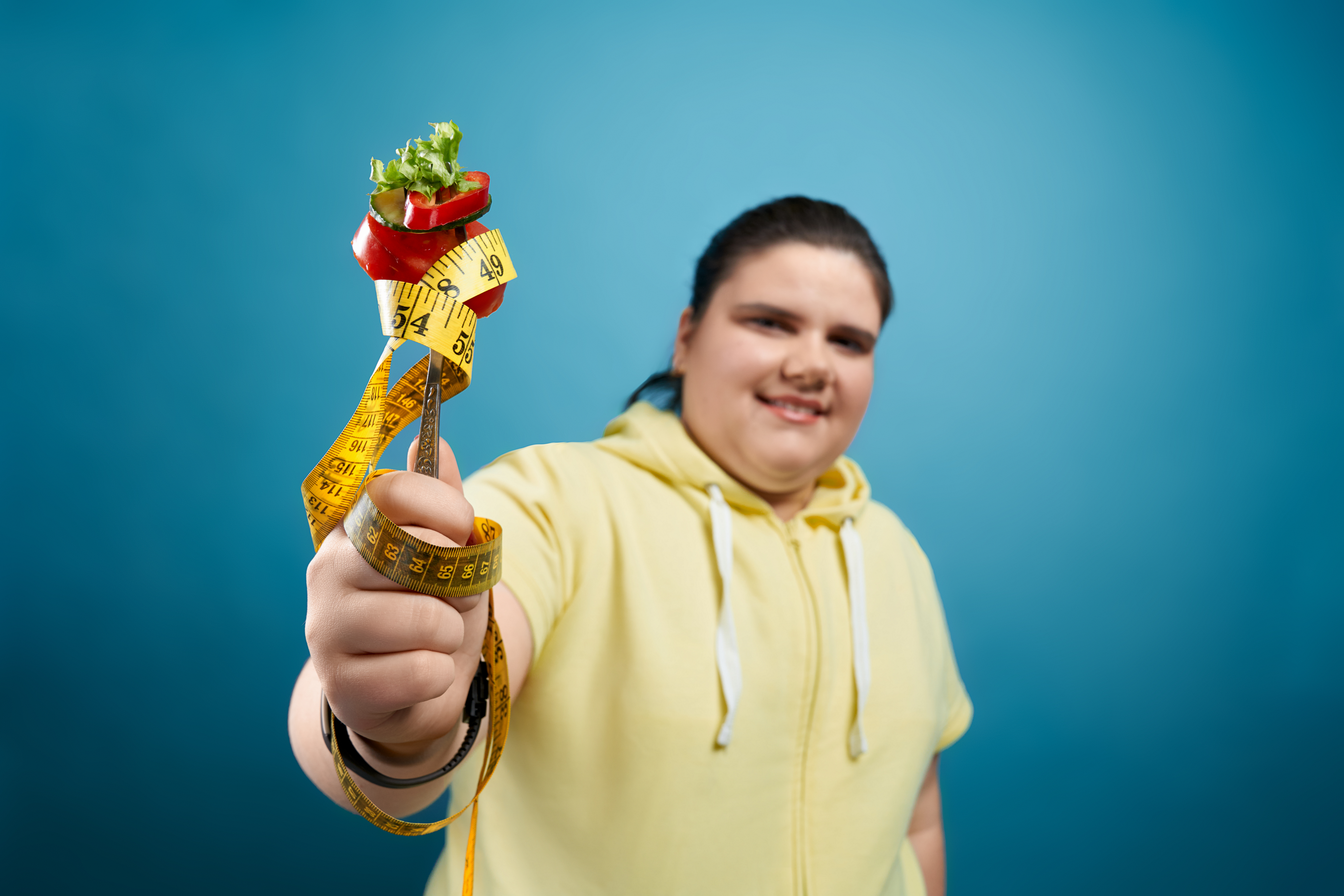 fat girl holding fork with vegetables and measurin 2025 03 24 16 10 12 utc